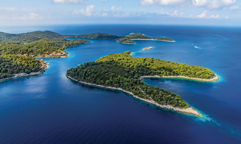 A Croatia yacht charter sails to Adriatic islands covered in lush wildlife set in blue waters