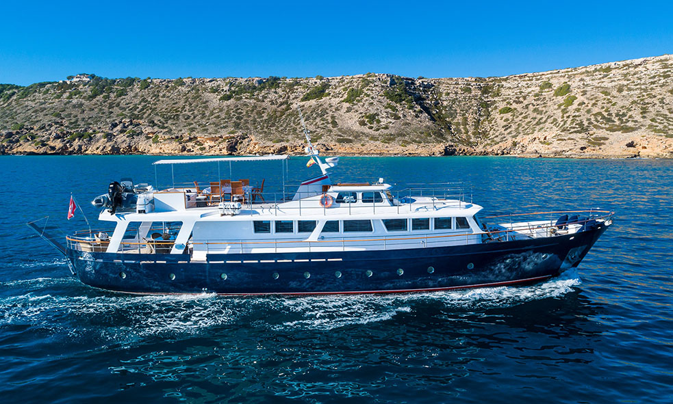 24.34m / 80' Cantieri Navali Lavagna BLACK PEPPER yacht against blue sky and rocky landscape