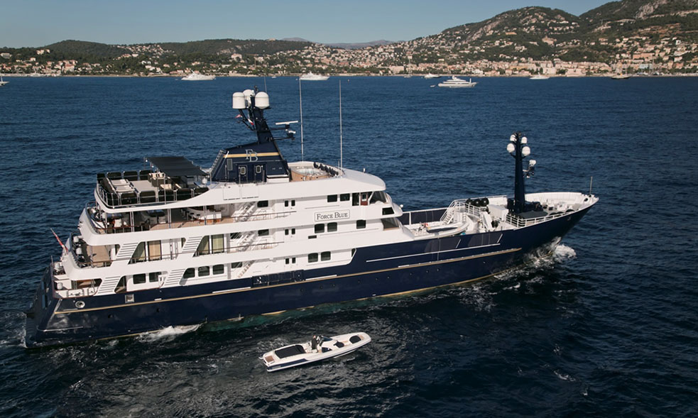 Superyacht FORCE BLUE pictured on blue sea with mountains in background